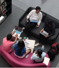 Students working on laptops in a group