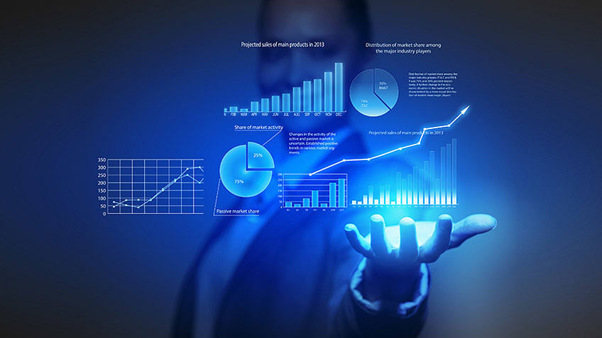 Two people looking at large screens with data utilizing cloud reporting for business.